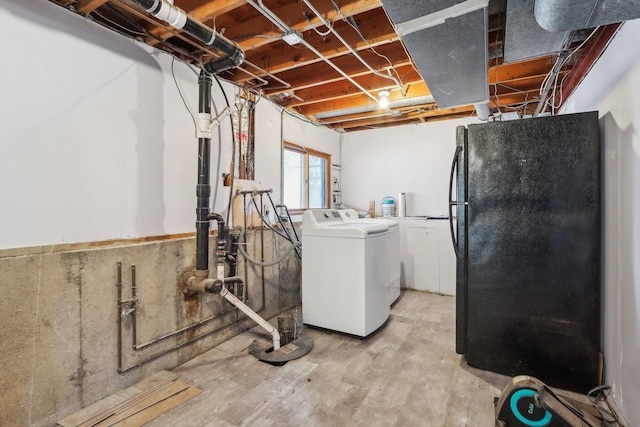 basement featuring black fridge and washer and dryer