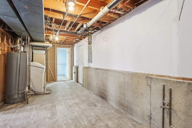 basement featuring washer / clothes dryer, electric panel, and gas water heater