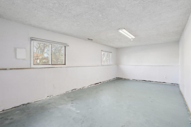 spare room with a textured ceiling