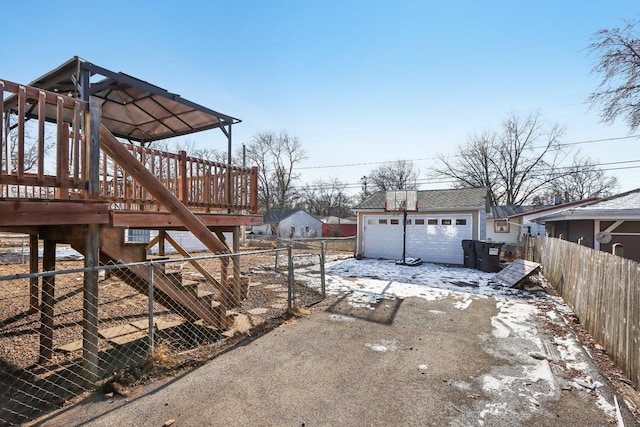 yard covered in snow with a garage and an outbuilding