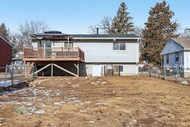 rear view of property with a gazebo and a deck