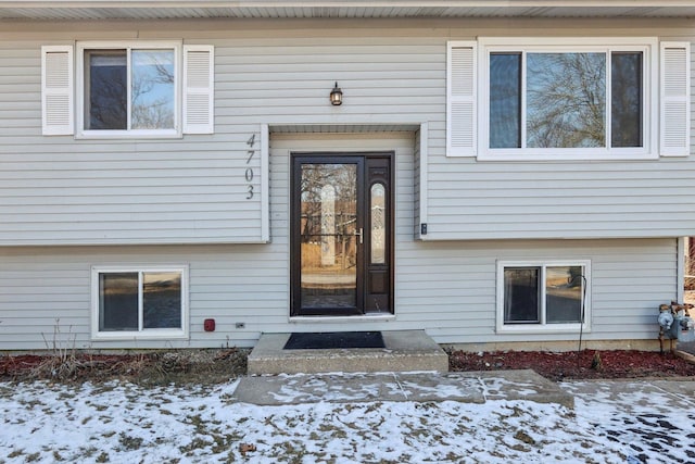 view of snow covered property entrance