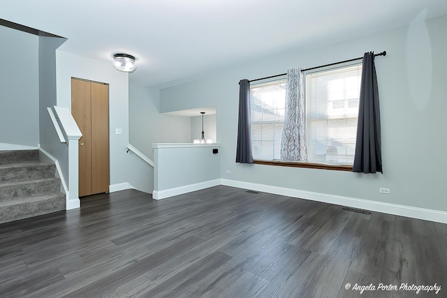 spare room with dark hardwood / wood-style floors