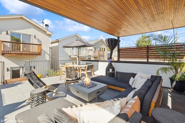 view of patio featuring an outdoor living space with a fire pit