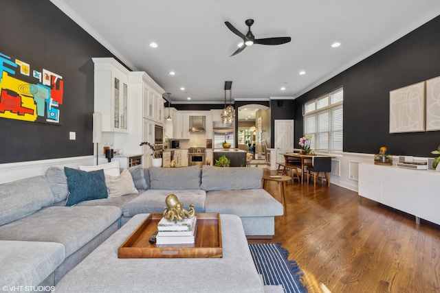 living room with ceiling fan, dark hardwood / wood-style floors, and ornamental molding