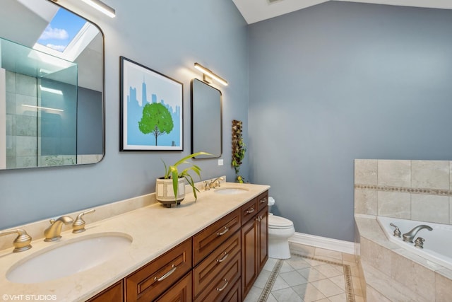 bathroom featuring toilet, tile patterned floors, a relaxing tiled tub, and vanity