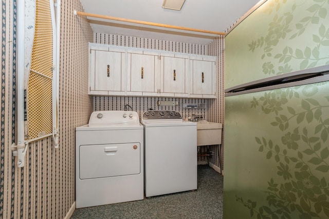 laundry area with cabinets and separate washer and dryer