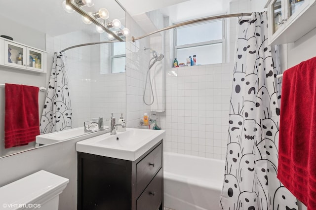 full bathroom featuring vanity, a healthy amount of sunlight, shower / bath combination with curtain, and toilet