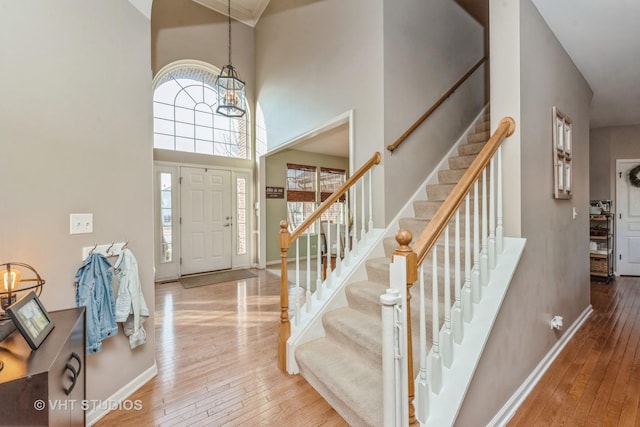 entrance foyer with a high ceiling and wood-type flooring