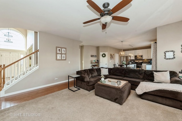 living room featuring light hardwood / wood-style floors and ceiling fan