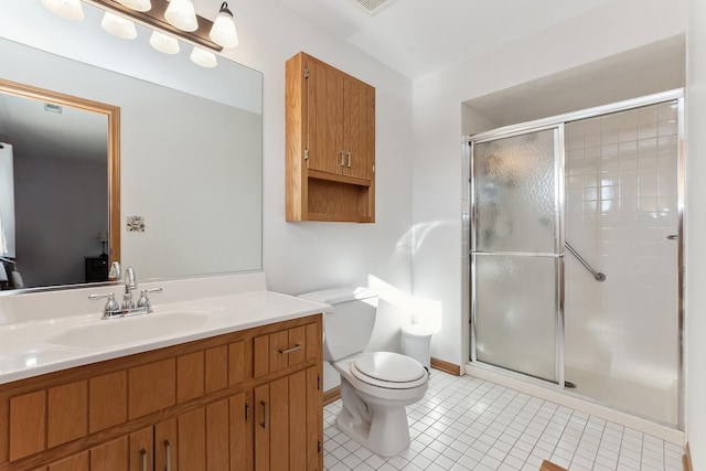 bathroom featuring tile patterned flooring, toilet, vanity, and walk in shower