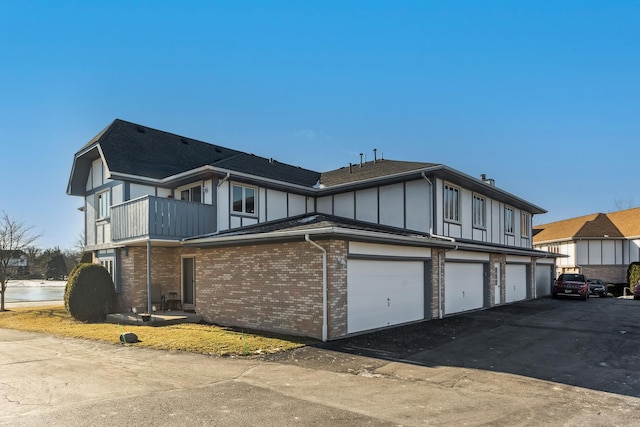 exterior space featuring a balcony and a garage