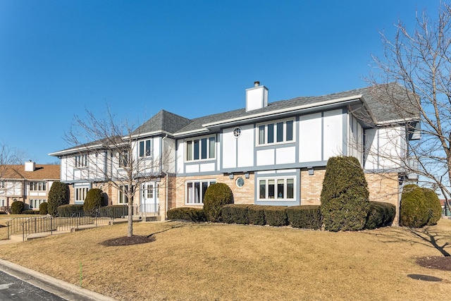 tudor house featuring a front yard