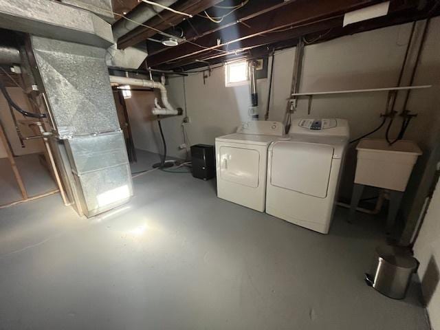 basement featuring sink and independent washer and dryer