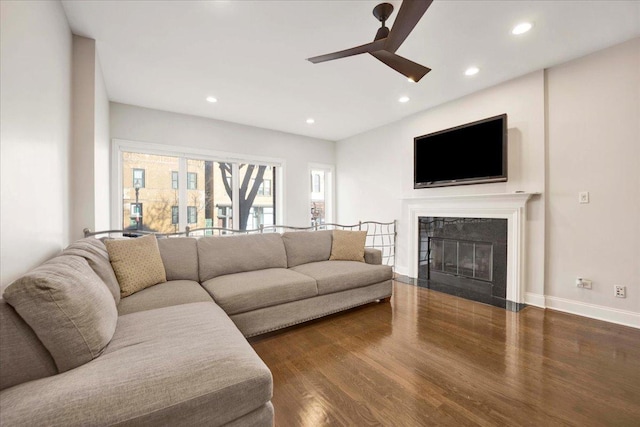 living room with ceiling fan and dark wood-type flooring