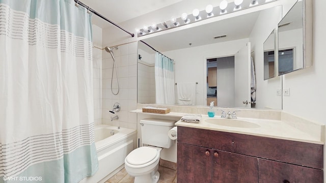 full bathroom with shower / bath combo with shower curtain, tile patterned floors, vanity, and toilet