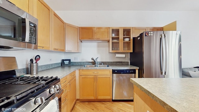 kitchen with light hardwood / wood-style floors, sink, light brown cabinets, and appliances with stainless steel finishes