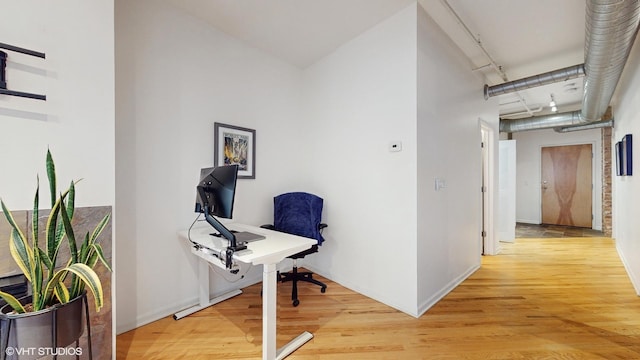 corridor with hardwood / wood-style flooring