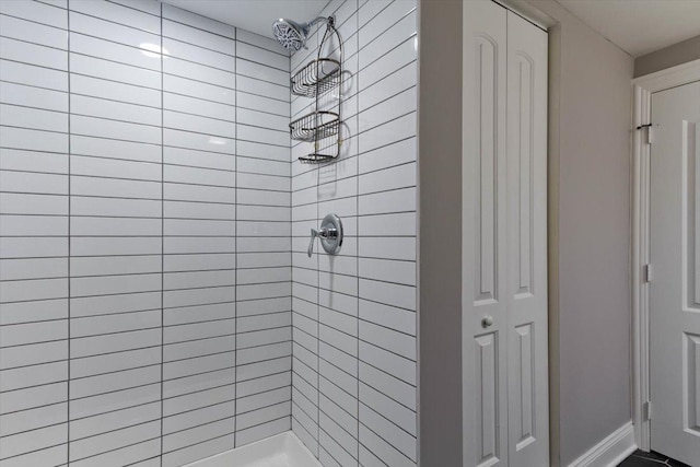 bathroom with a tile shower