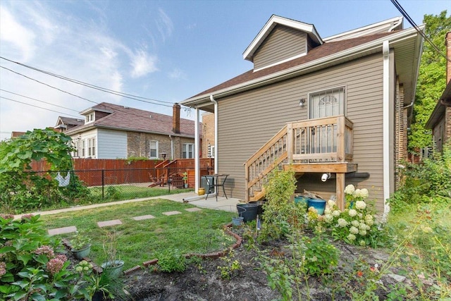 rear view of property featuring a yard and a patio