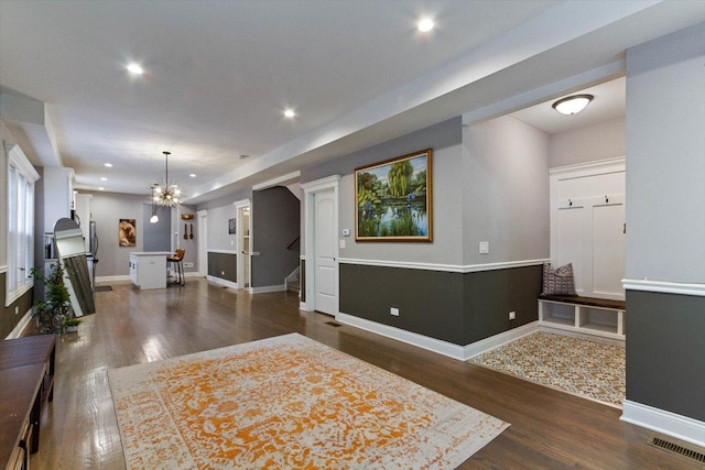 interior space with an inviting chandelier and dark hardwood / wood-style flooring