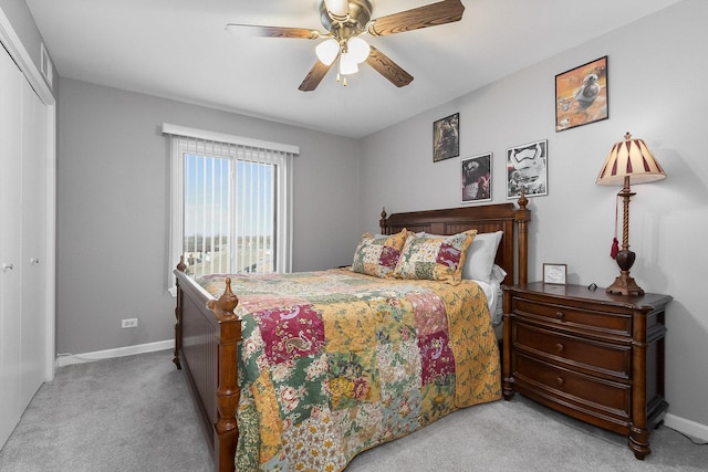 bedroom with light carpet, ceiling fan, and a closet