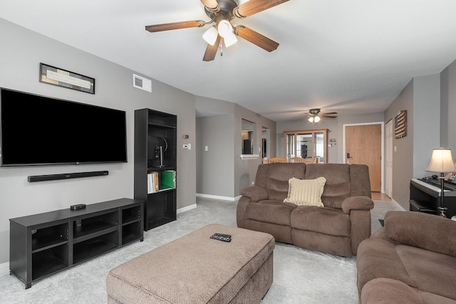 carpeted living room with ceiling fan