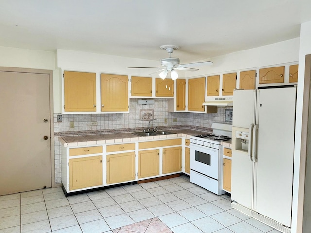 kitchen with ceiling fan, sink, backsplash, white appliances, and tile countertops