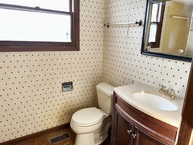 bathroom featuring toilet and vanity