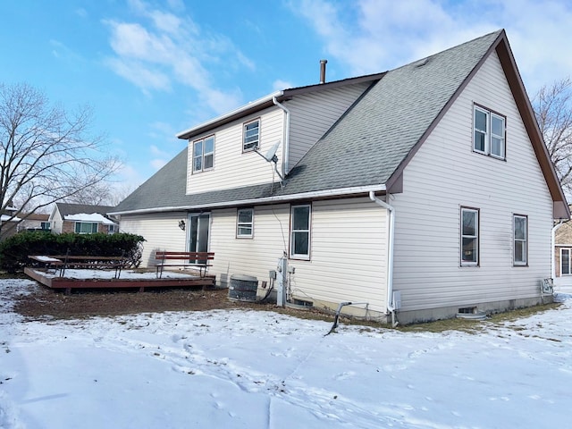 view of snow covered rear of property