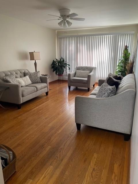 living room with hardwood / wood-style floors and ceiling fan