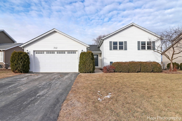 view of front of home featuring a garage and a front lawn