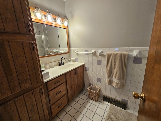 bathroom featuring tile patterned floors, tile walls, and vanity