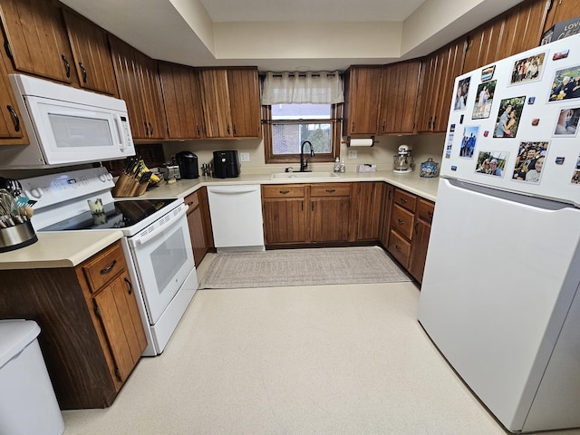 kitchen with sink and white appliances