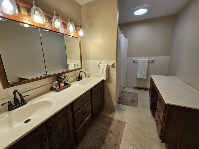 bathroom with vanity and tile walls