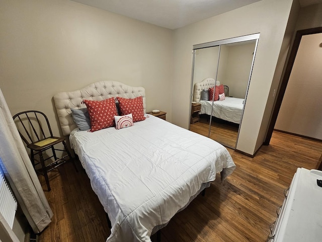 bedroom featuring a closet and dark hardwood / wood-style floors