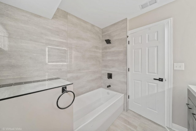 bathroom featuring vanity and tiled shower / bath combo