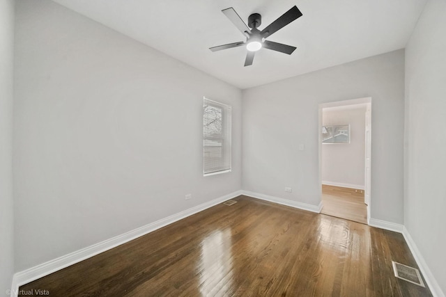 empty room featuring ceiling fan and dark hardwood / wood-style flooring