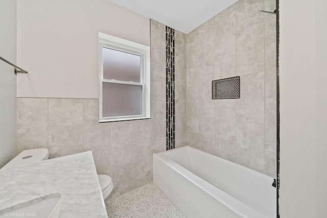 bathroom featuring vanity, toilet, tile walls, and tile patterned flooring