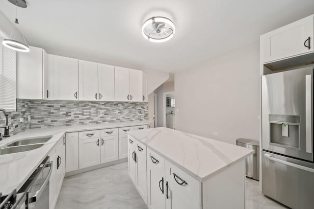 kitchen with sink, white cabinets, a center island, and stainless steel appliances