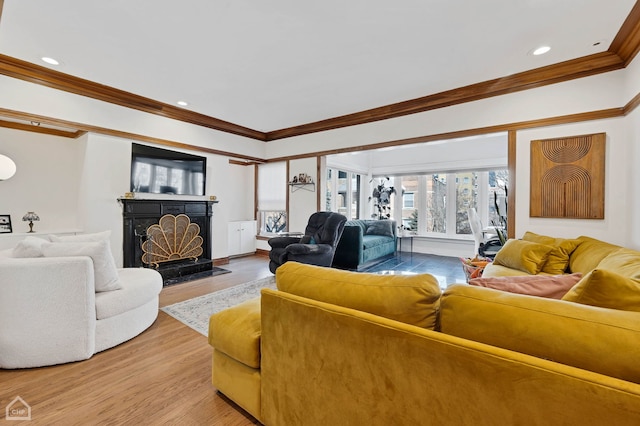 living room with hardwood / wood-style flooring and ornamental molding