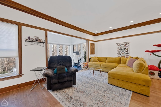 living room featuring a wealth of natural light, ornamental molding, and light hardwood / wood-style floors