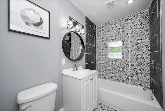 full bathroom with tiled shower / bath combo, vanity, and toilet