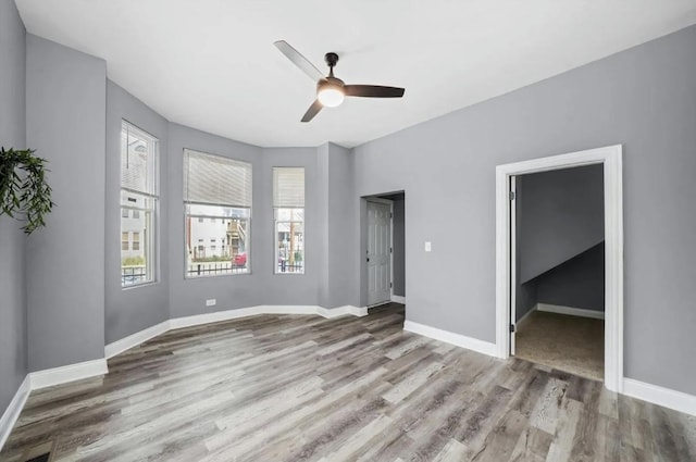 unfurnished room featuring ceiling fan and light wood-type flooring