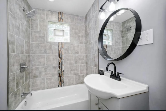 bathroom with vanity and tiled shower / bath