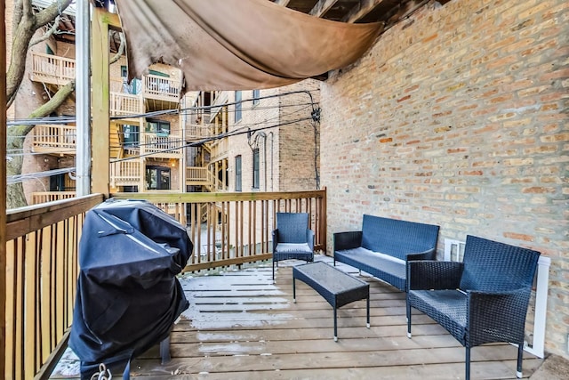 wooden deck with grilling area and an outdoor hangout area