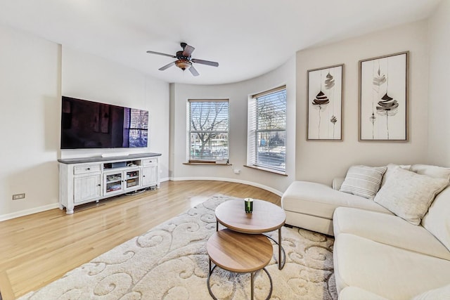 living room featuring ceiling fan and light wood-type flooring