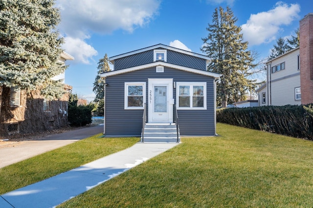 bungalow-style home with a front yard