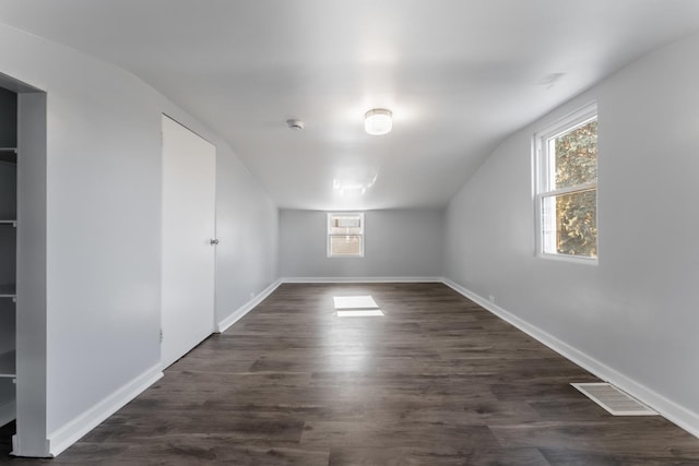 additional living space featuring dark hardwood / wood-style floors and vaulted ceiling