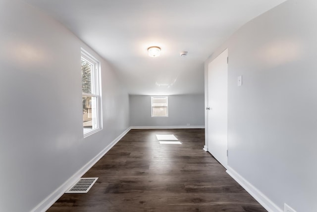 additional living space with dark hardwood / wood-style floors